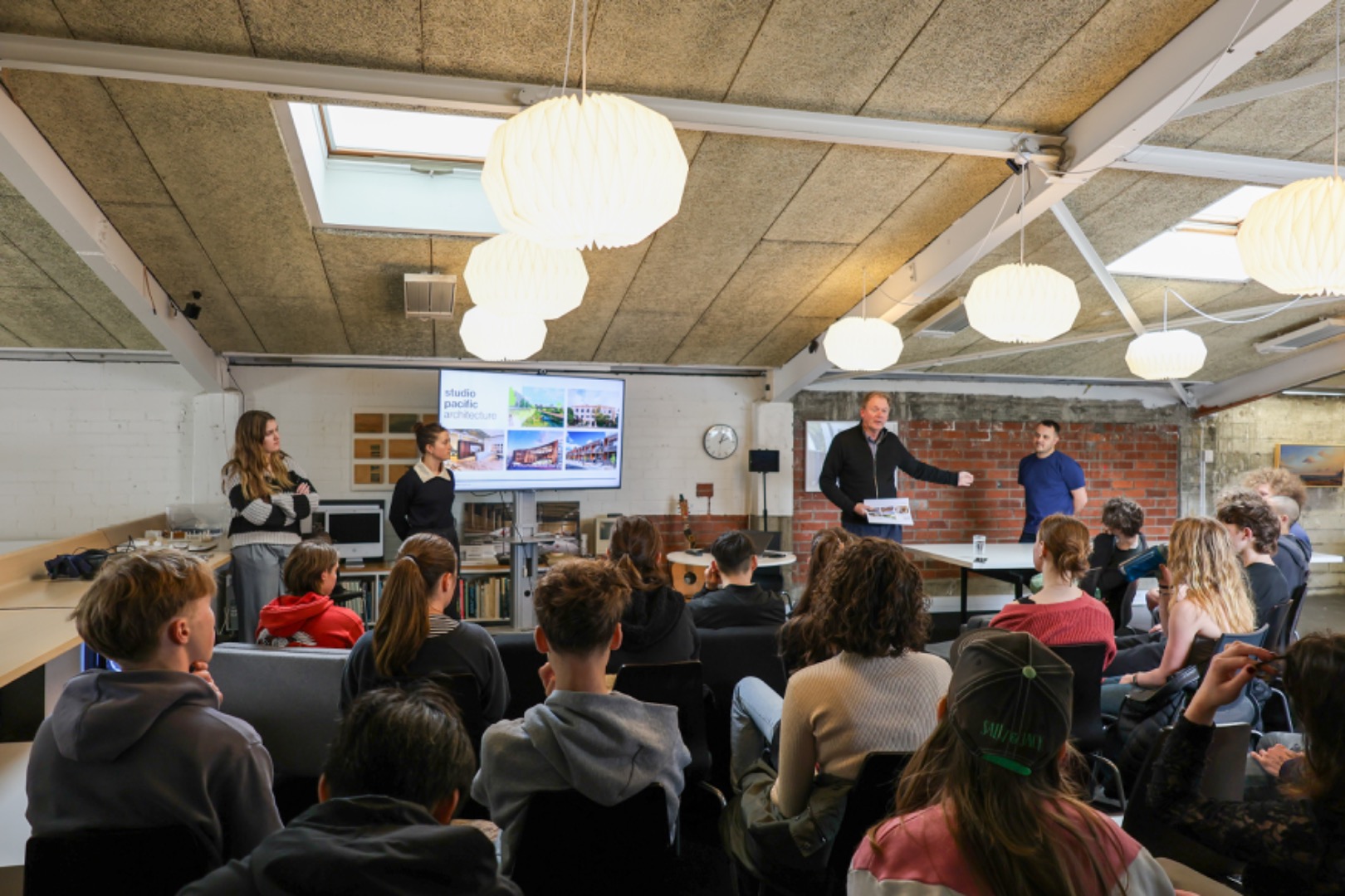 From left: Tayla Lindsay, Charlotte Warren, Evžen Novák, and Nick du Bern present to students from Wellington High School.